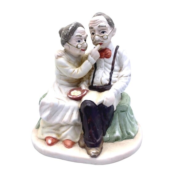 Vintage Figurine Of Elderly Couple Sitting On A Bench With Glasses & Red Bow Tie - Picture 1 of 7